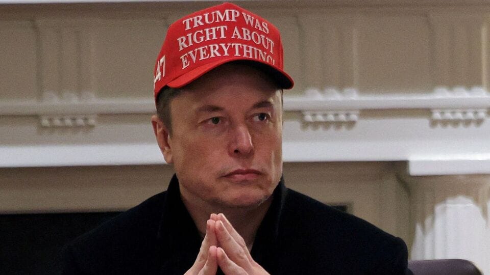 Tesla CEO Elon Musk wears a Trump Was Right About Everything hat while attending a cabinet meeting at the White House, in Washington, D.C., U.S., March 24, 2025. REUTERS/Carlos Barria/File Photo