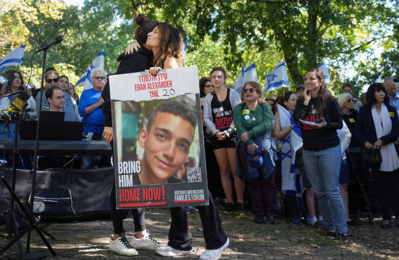  The mother of Israeli hostage Edan Alexander hugs an organizer at a pro-Israel rally, nearly one year after Hamas