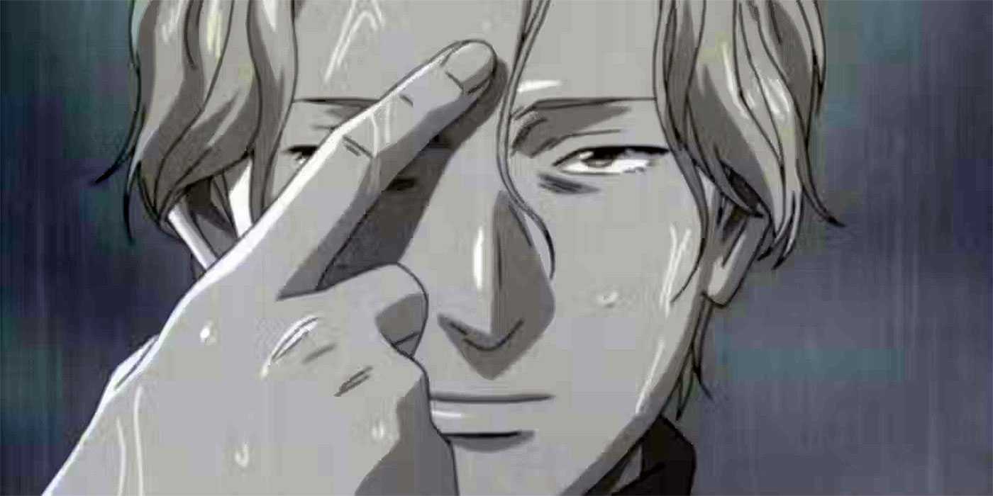 Johan Liebert points toward his forehead with his index finger in Monster.