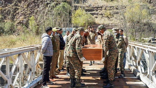 Indian Army officials facilitate the return of the mortal remains of two missing youths from Pakistan-Occupied Kashmir (POJK), at Uri in Baramulla on Saturday.