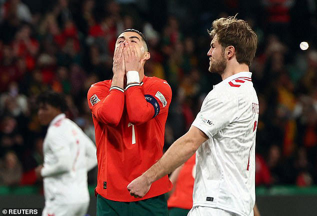 Bruno Fernandes appears to celebrate before Cristiano Ronaldo's penalty  against Denmark... only for the 40-year-old to see his shocking effort saved