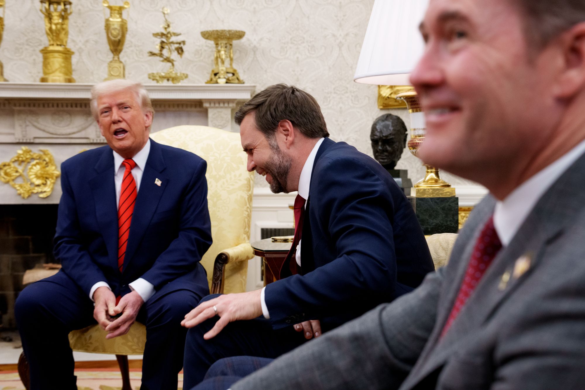 National Security Adviser Michael Waltz and JD Vance laugh as Donald Trump speaks Oval Office meeting on March 13 (Getty Images)