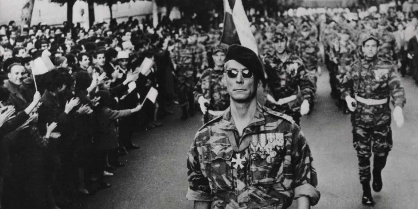 Jean Martin as Colonel Philippe Mathieu marching during a parade in The Battle of Algiers