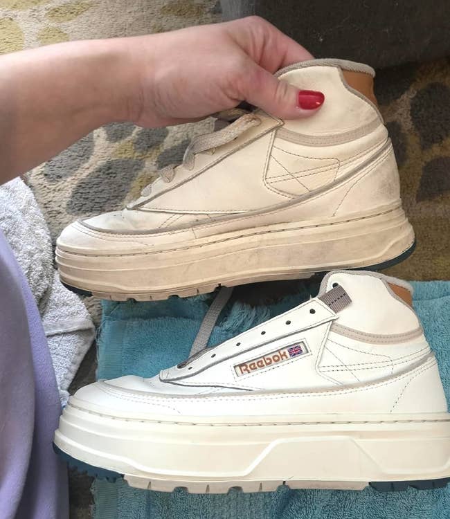 Two sneakers, one still brown with dirt and grime, the other after cleaning, white and like new