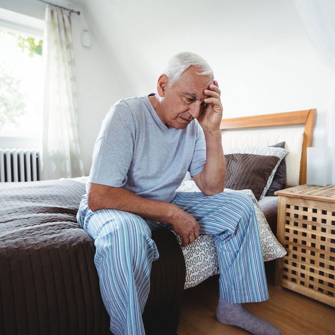 shutterstock_584264557-tired-man-sitting-on-bed