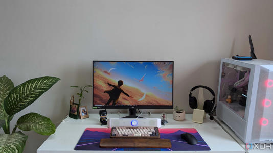 A PC setup showing a PC, monitor, and desk with accessories