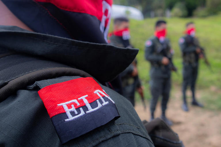 TOPSHOT - National Liberation Army ELN rebels of the Manuel Vazquez Castano northeastern war front stand guard at Catatumbo region, Colombia on March 8, 2025. Commanders from Colombia's National Liberation Army guerrilla group have vowed to repel a government counteroffensive in the country's northeast, warning years of "total peace" risk turning into "total war".  (Photo by STRINGER / AFP) (Photo by STRINGER/AFP via Getty Images)