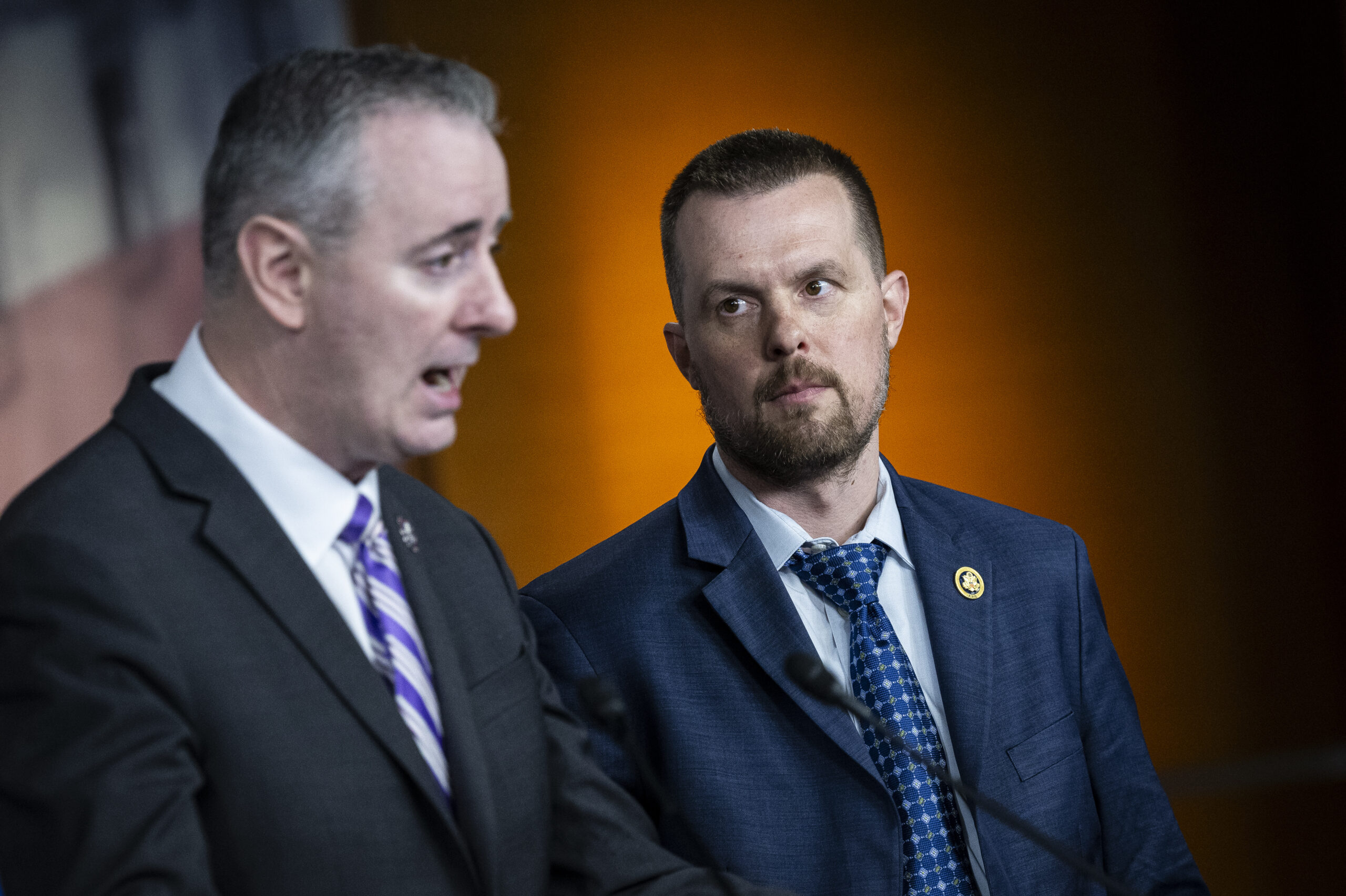 Jared Golden (D-ME) listens to Representative Brian Fitzpatrick