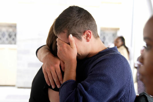 A relative hugs Belgian national Seppe Lodewijck (AP Photo/Brian Inganga)