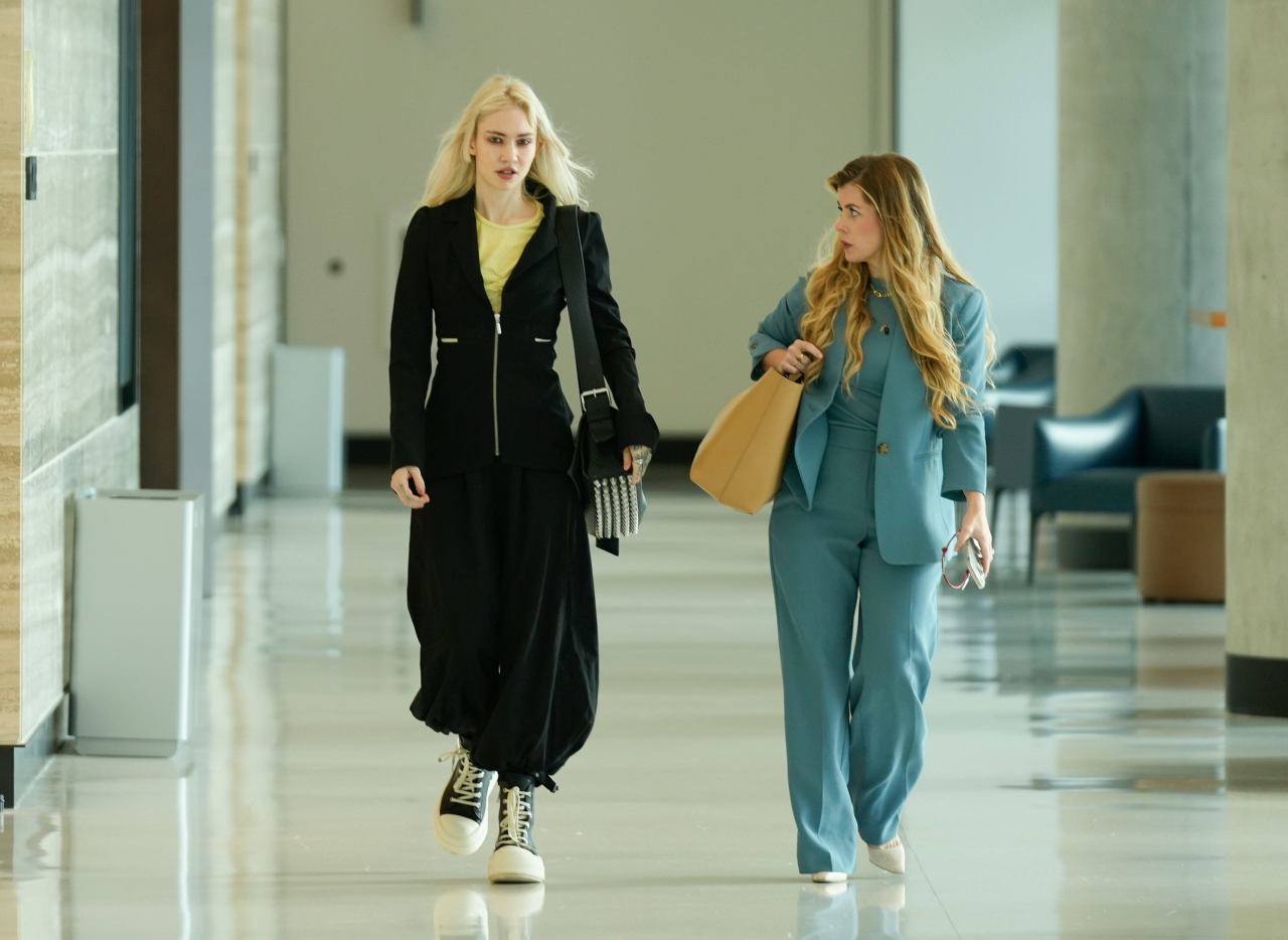 Grimes, left, arrived for a custody hearing at an Austin court last year.