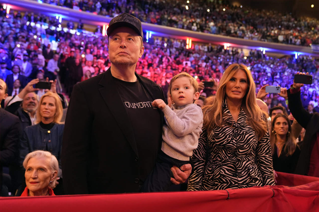 Musk, holding X, attended a Trump campaign event at New York’s Madison Square Garden last year with his mother, Maye Musk, left, and Melania Trump.