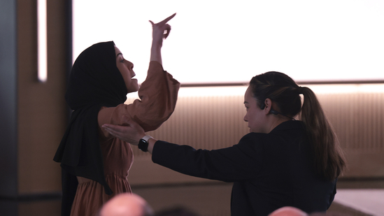 CORRECTS DATE - A pro-Palestinian demonstrator, Ibtihal Aboussad, is escorted away by security as they interrupt Microsoft AI CEO Mustafa Suleyman during a presentation of the company's AI assistant, Copilot, ahead of a 50th Anniversary presentation at Microsoft headquarters, Friday, April 4, 2025, in Redmond, Wash. (AP Photo/Jason Redmond)
