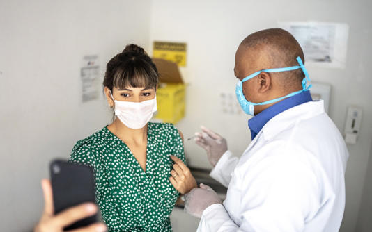 Woman holds phone in hospital