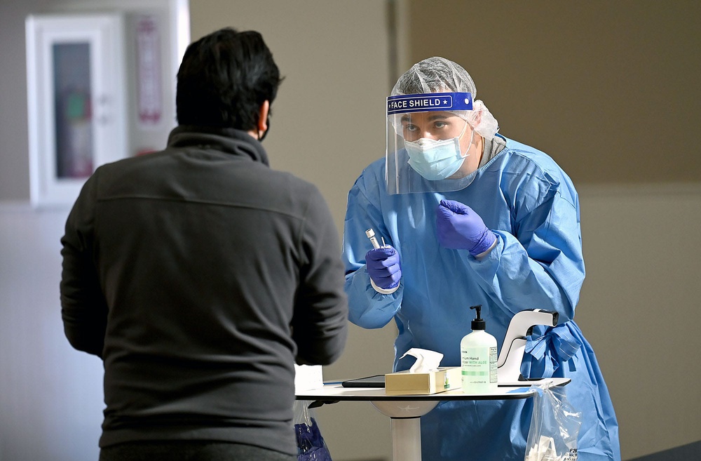 Nurse explains the nasal swab at a COVID-19 testing site