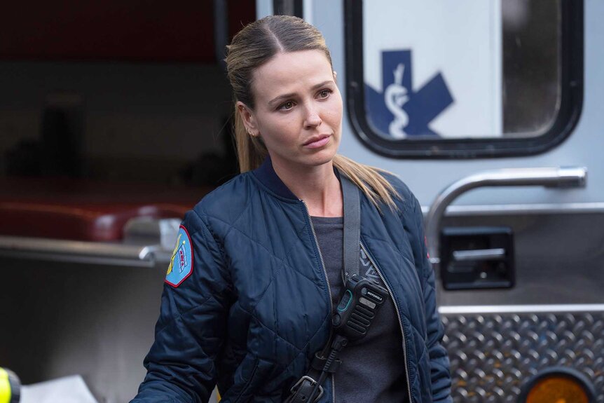 Lizzie Novak standing outside a paramedic truck in Chicago Fire Season 13, Episode 9.