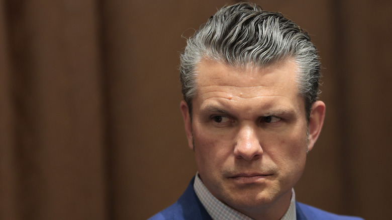 Pete Hegseth looks off to the side