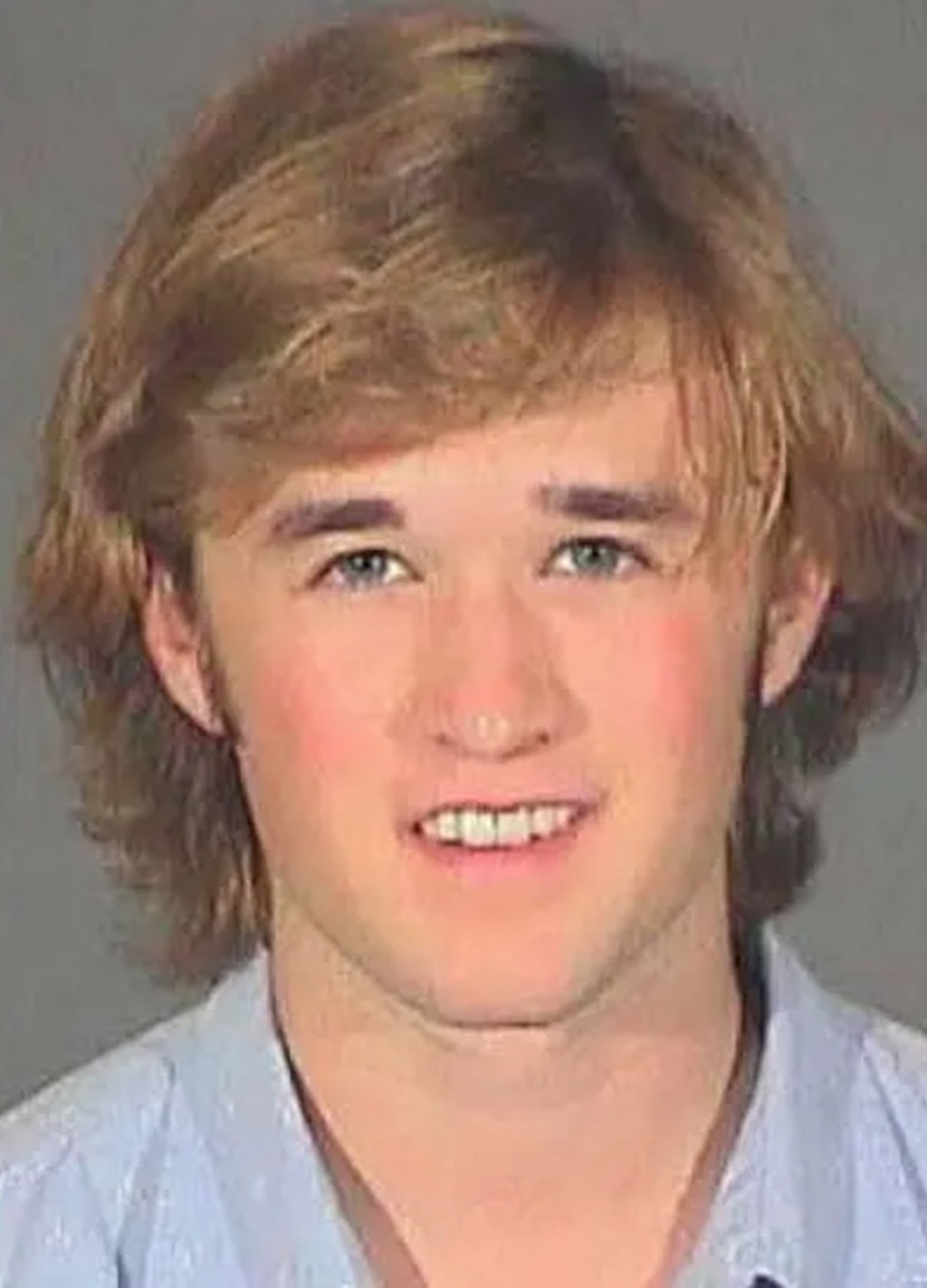 Haley Joel Osment offers big smile in mugshot after arrest for public