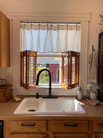 Kitchen sink with sheer curtains