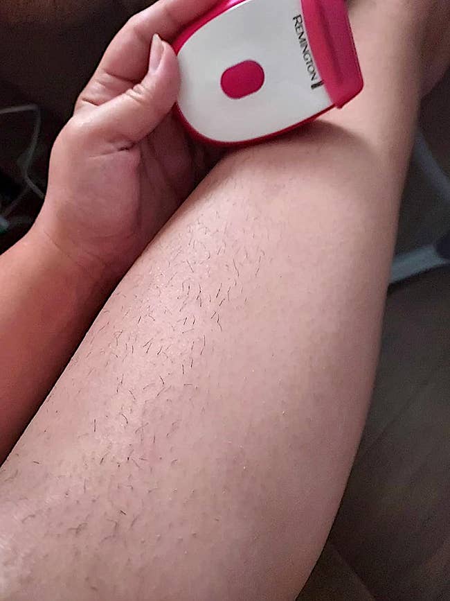 A hand holds a Remington epilator over a leg, demonstrating hair removal in a shopping-related context