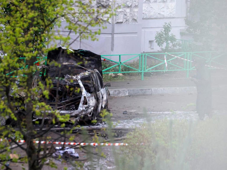A destroyed car sits in the courtyard of residential buildings following a blast in Balashikha, Russia, on April 25, 2025.