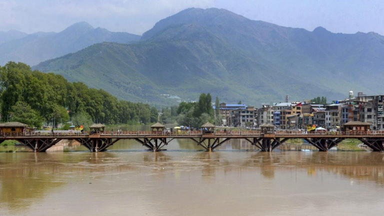 Swollen Jhelum river following heavy rains, in Srinagar. PTI