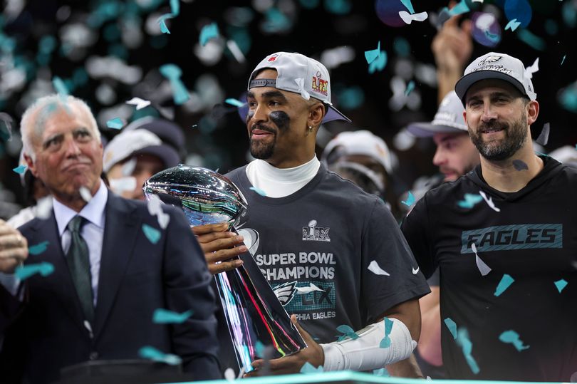 NEW ORLEANS, LOUISIANA - FEBRUARY 09: Philadelphia Eagles owner Jeffrey Lurie, Jalen Hurts #1, and head coach Nick Sirianni react with the Vince Lombardi Trophy after winning Super Bowl LIX against the Kansas City Chiefs at Caesars Superdome on February 09, 2025, in New Orleans, Louisiana. The Eagles defeated the Chiefs 40-22. (Kara Durrette/Getty Images)