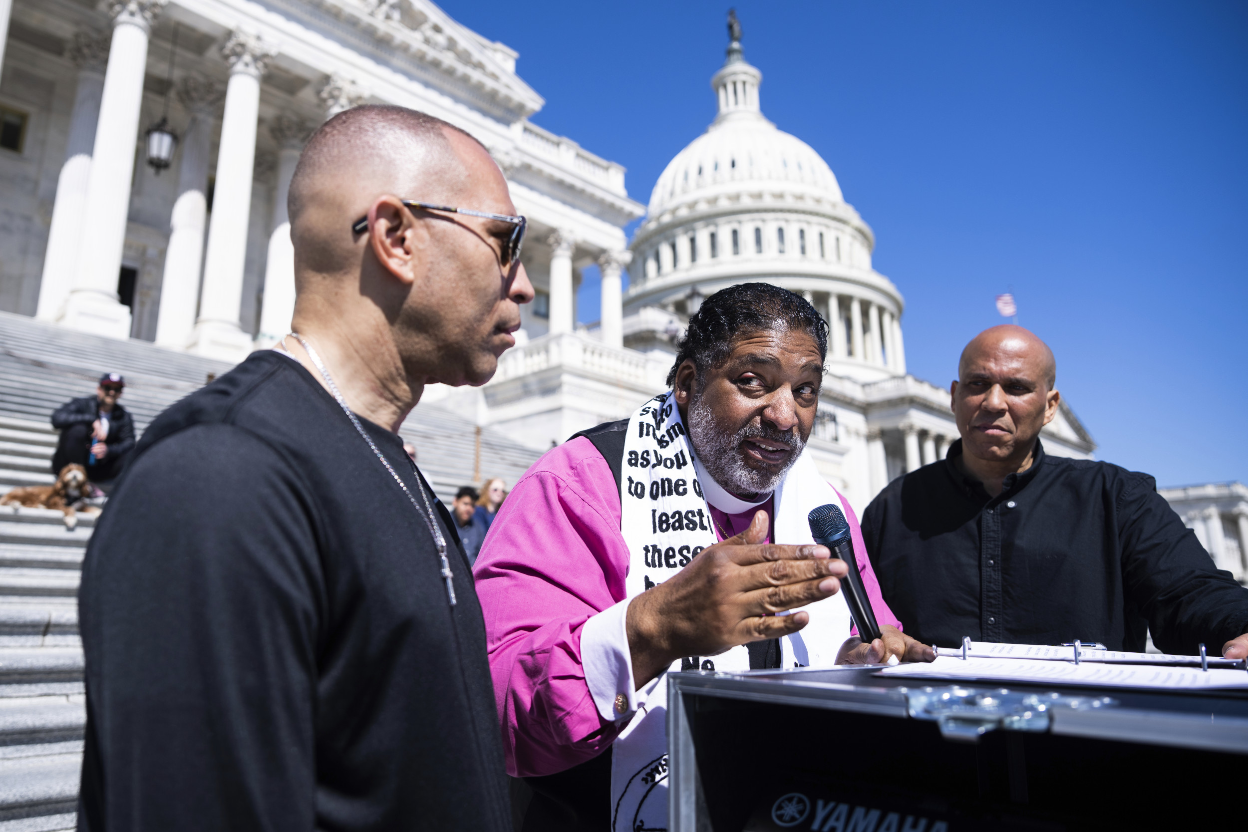 From left, House Minority Leader Hakeem Jeffries, D-N.Y., Rev. Dr. William Barber, and Sen. Cory Booker, D-N.J., conduct a live-streamed conversation with Americans focused on "our common values, our faith traditions and the moral moment facing our nation," on the House steps of the U.S. Capitol on Sunday, April 27, 2025. AP