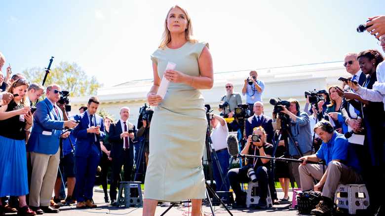 Karoline Leavitt walking away from reporters.