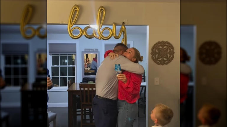 Karoline Leavitt and Nicholas Riccio hug at their gender reveal.