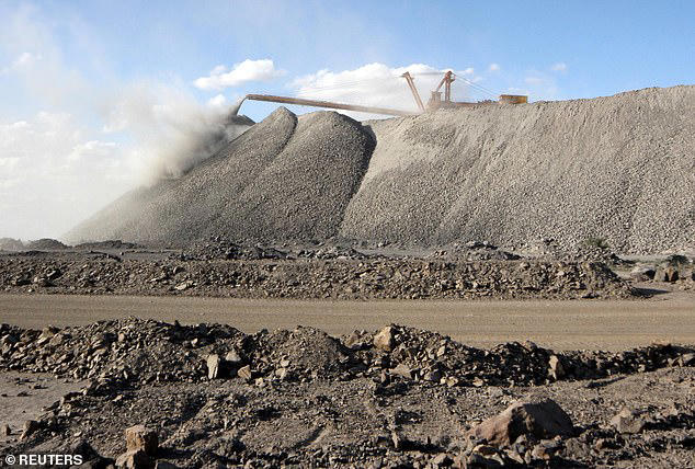 China has rich reserves of thorium which could help improve the safety of existing nuclear fission. Pictured, mining machine is seen at the Bayan Obo mine containing rare earth minerals, in Inner Mongolia, China