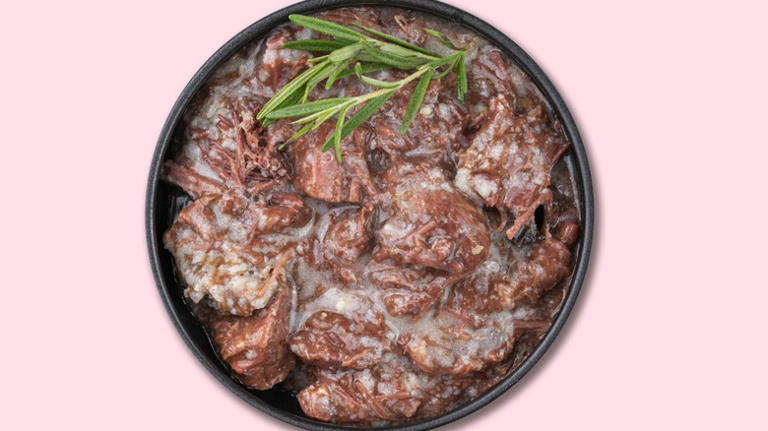 Canned beef stew, with a sprig of rosemary