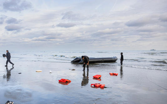 A migrant fails in his bid to reach Britain from a beach near Dunkirk, France - SAMEER AL-DOUMY/AFP