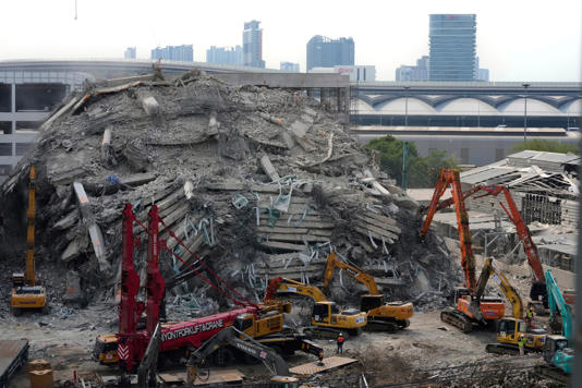 Heavy machineries are deployed to clear the rubble from an under-construction high-rise building that collapsed after an earthquake in Bangkok, Thailand (AP Photo/Manish Swarup)