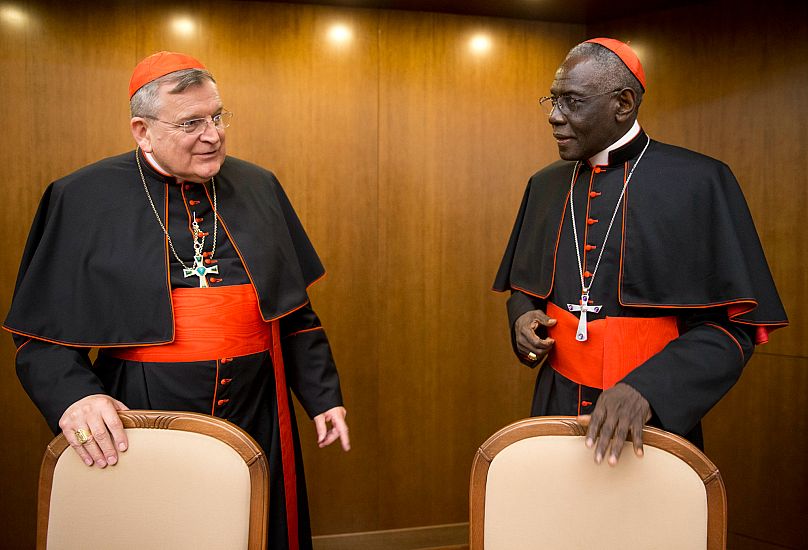 Cardinal Raymond Leo Burke, left, talks with Cardinal Robert Sarah in Rome, 14 October, 2015 AP Photo