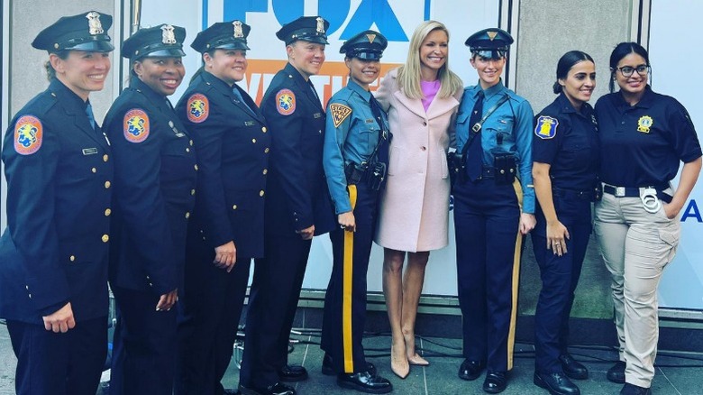 Ainsley Earhardt poses witth a group of female officers (2023)
