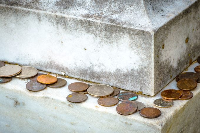 Coins on a Gravestone Getty 1219631870 Resize Recolor Crop DH RD Coins on a Gravestone and What it Means