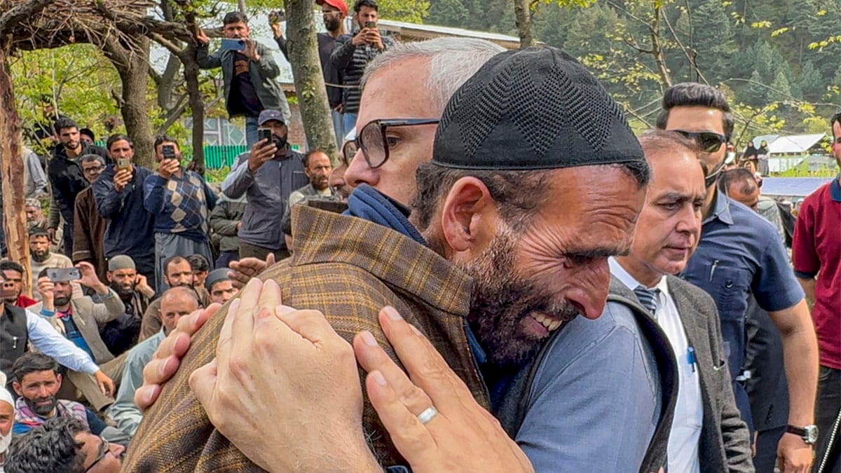 Jammu and Kashmir Chief Minister Omar Abdullah consoles the father of Adil Hussain Shah, a pony ride operator who was killed in a terrorist attack in Pahalgam on Tuesday, in Anantnag district on April 23, 2025. PTI