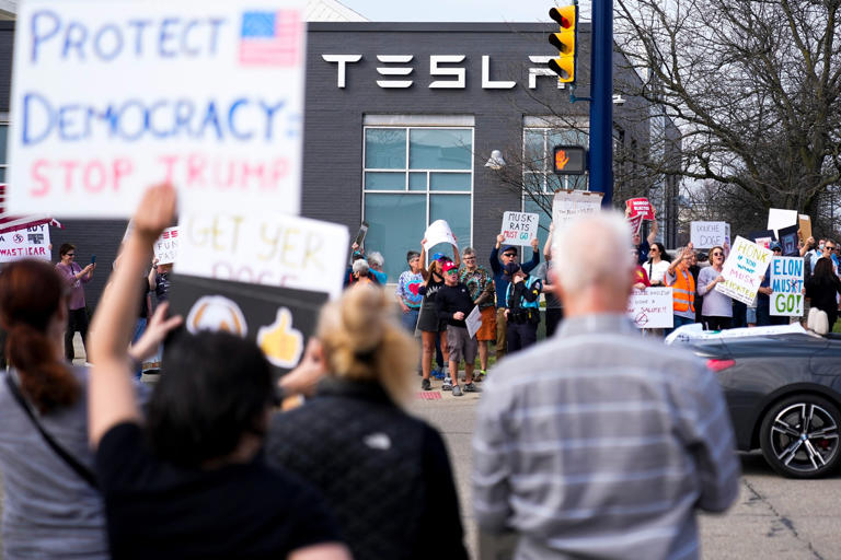 Protesters outside a Tesla dealership on March 29, 2025, in Columbus, Ohio.
