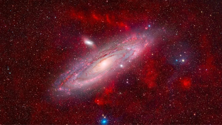 Stunning space photograph captures the majestic Andromeda Galaxy floating in a sea of faint, glowing nebulae