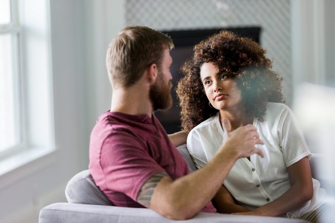 Mid adult woman listens seriously to husbands ideas