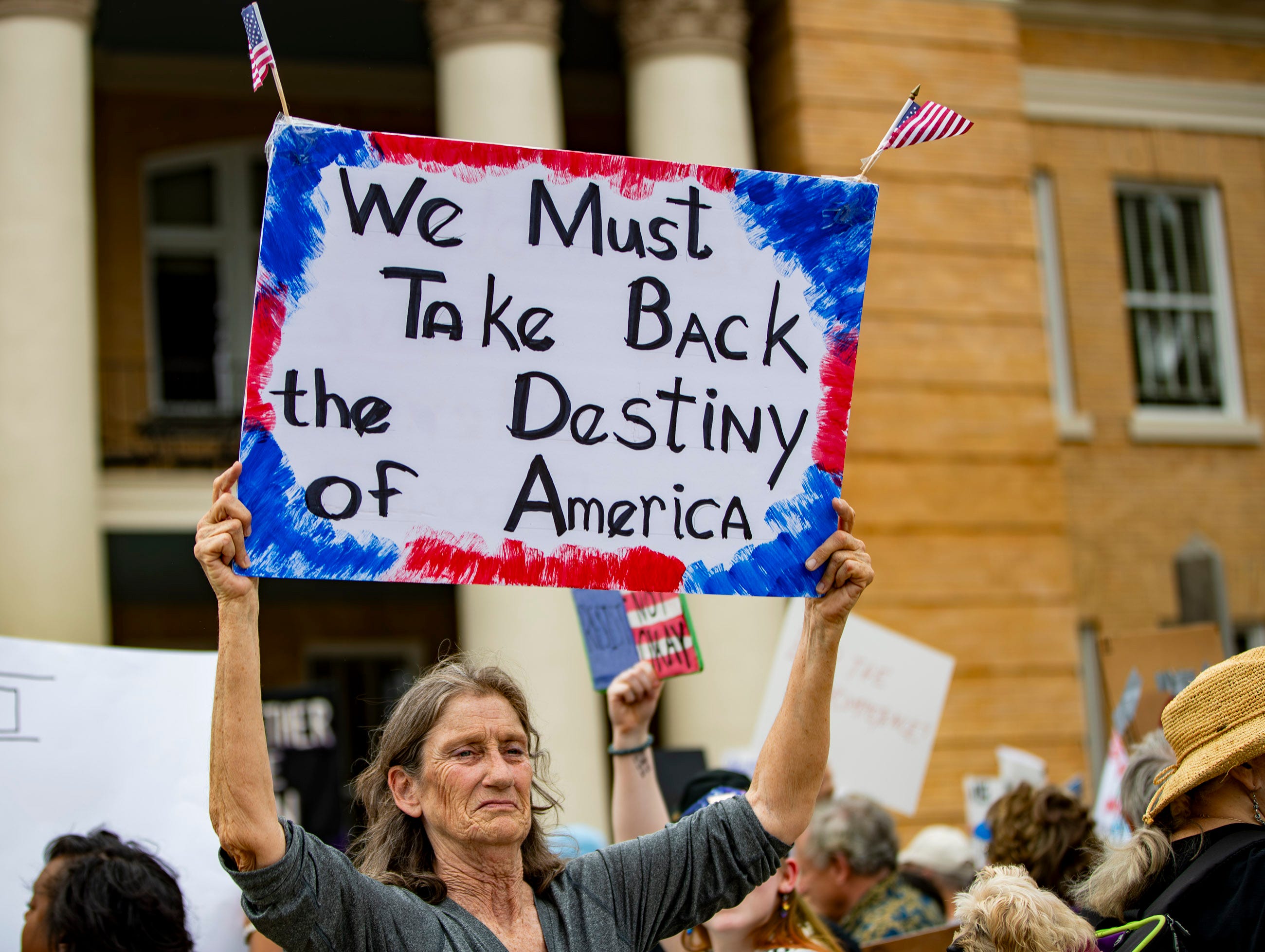 Protesters gather on the steps of the Historic Henderson County Courthouse in downtown Hendersonville, May 1, 2025, to protest the Trump administration.