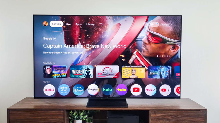 A TCL QM7K QD-Mini LED TV on a side table