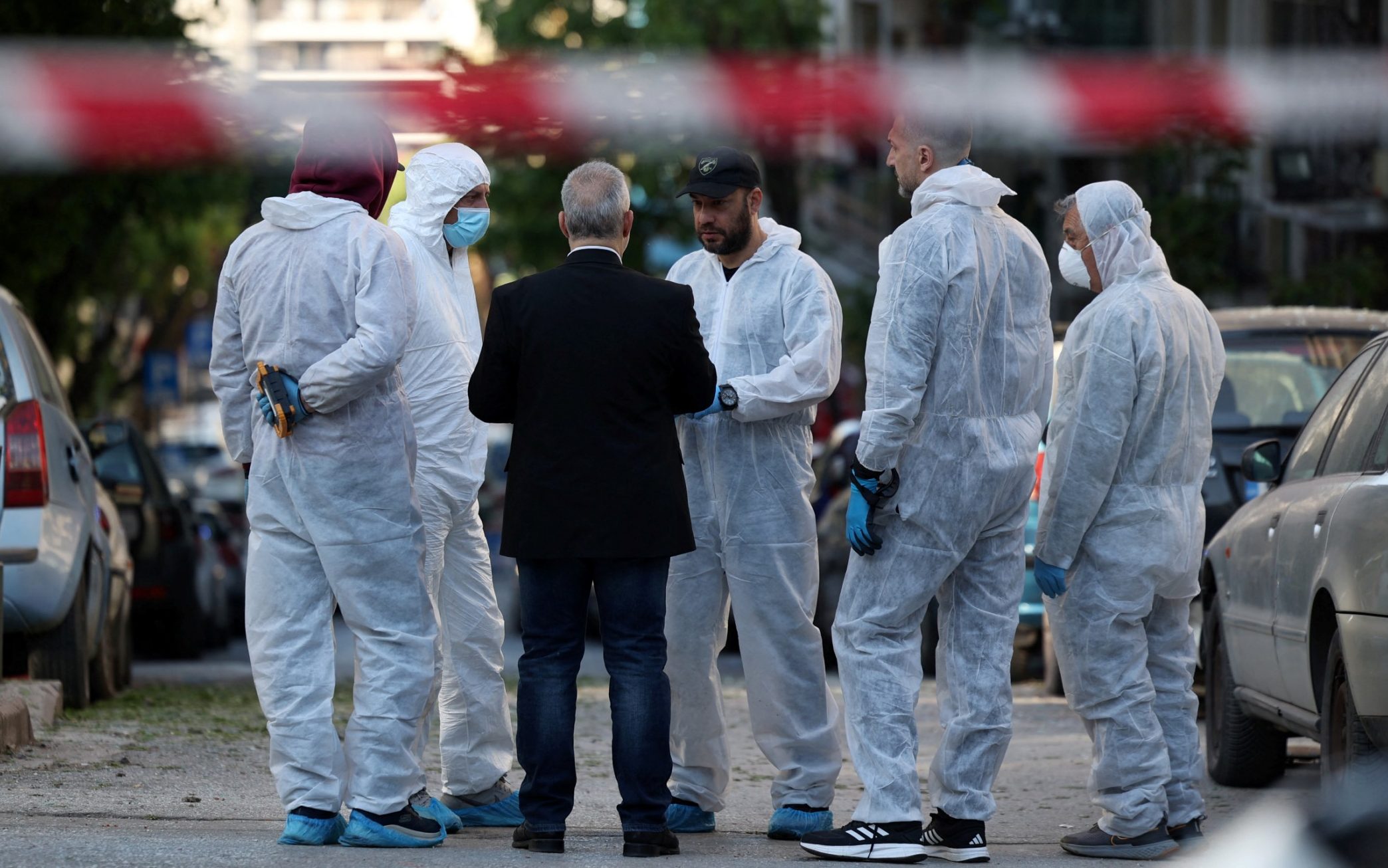 Forensic officers investigate after a bomb blast killed a woman in Thessaloniki - Alexandros Avramidis/Reuters