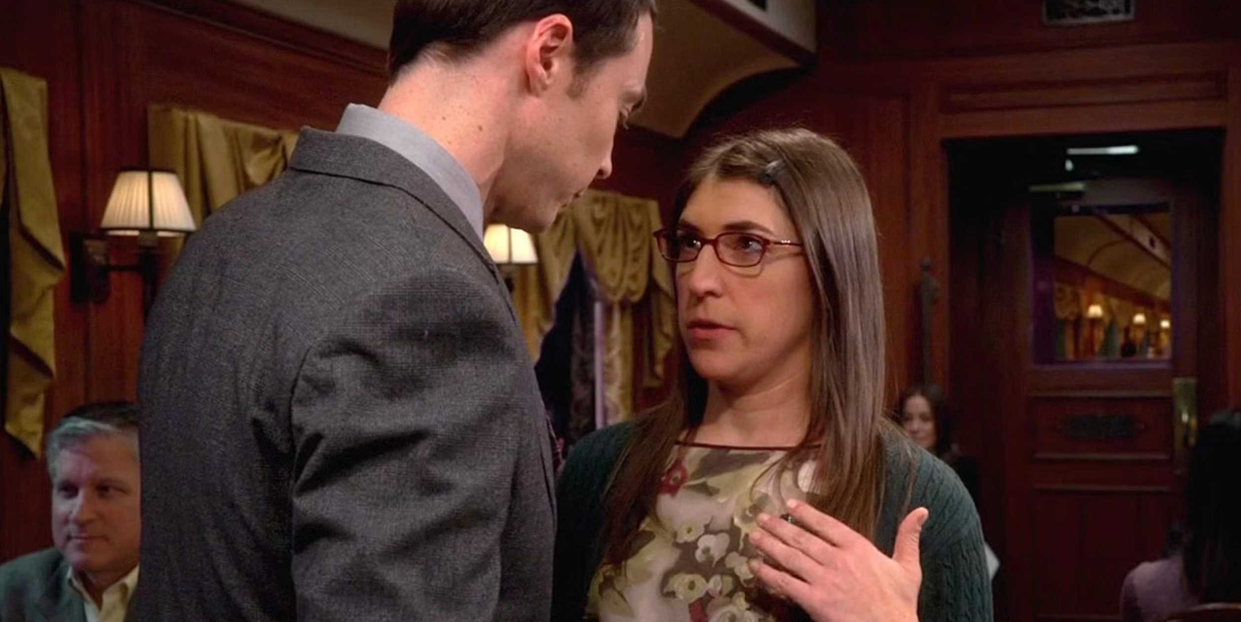 Sheldon leaning toward Amy in a train car in The Big Bang Theory season 7