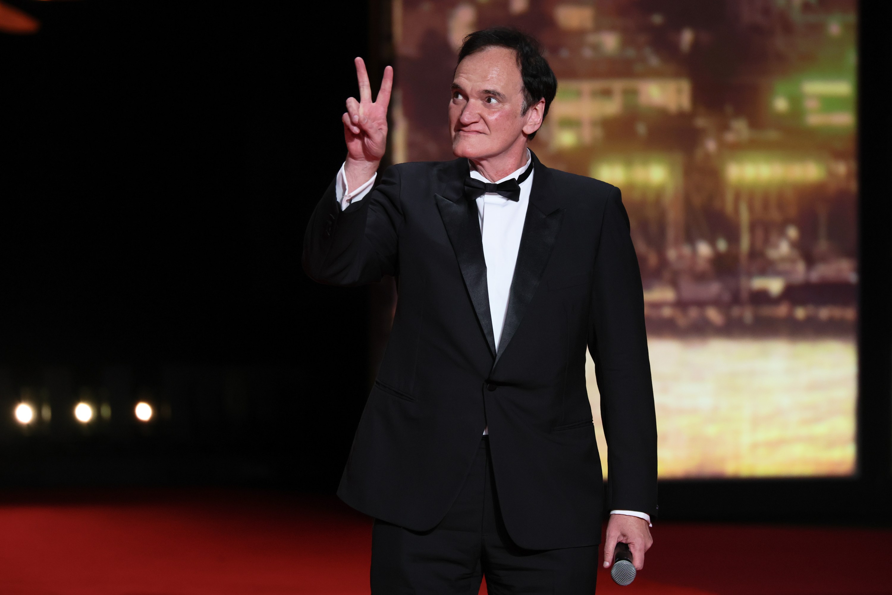 Tarantino offers up another peace sign.