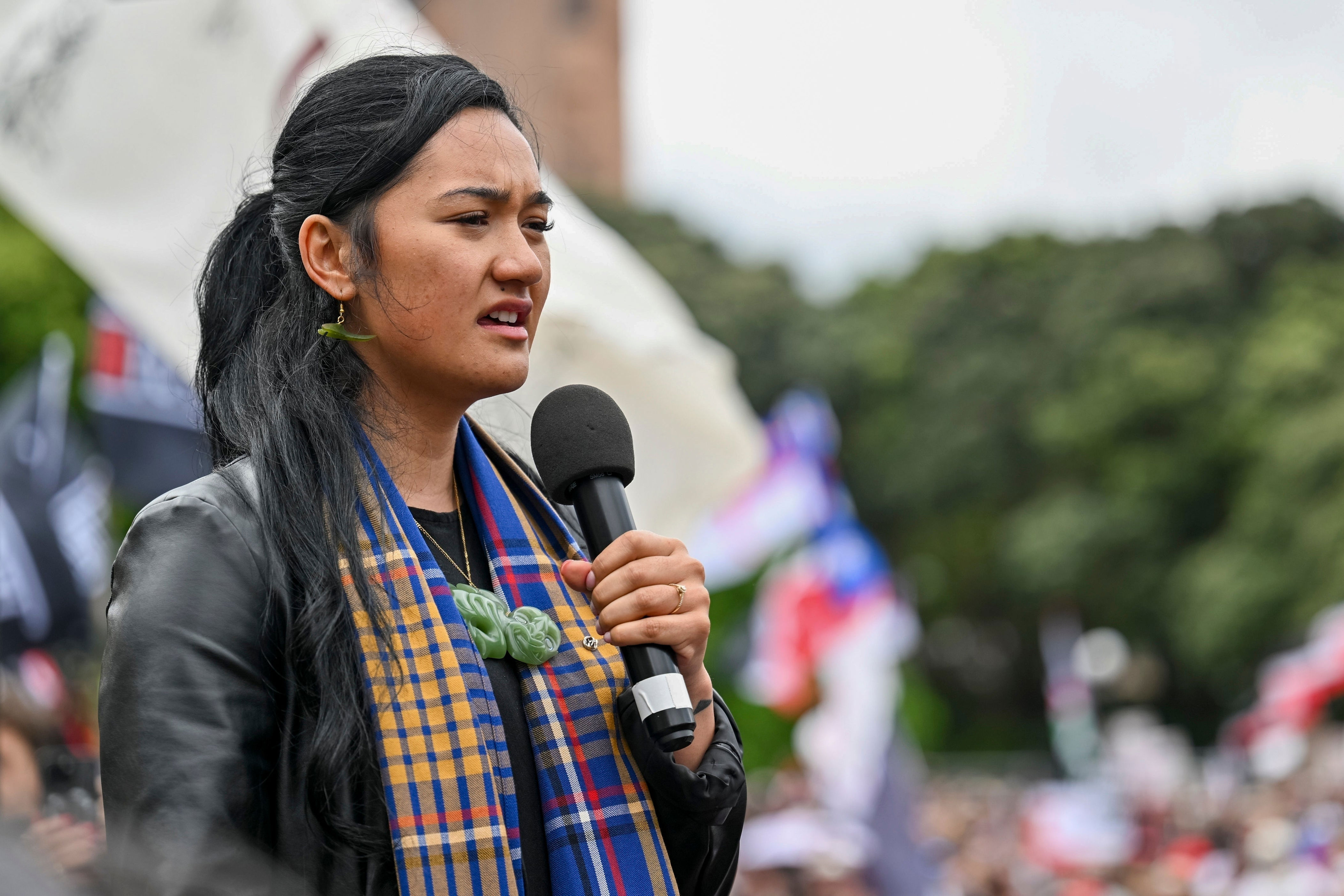 Hana-Rāwhiti Maipi-Clarke speaks to protesters outside parliament (AP)