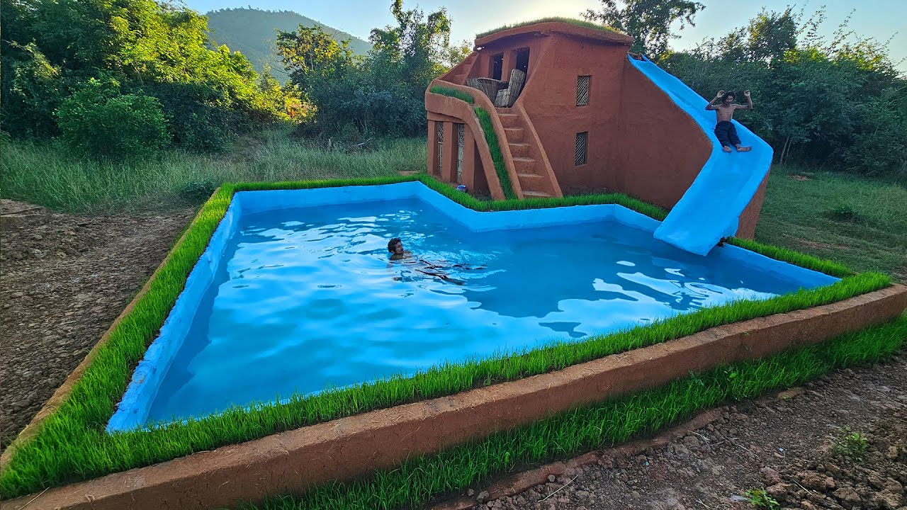A hand-built swimming pool with a water slide takes shape in a backyard