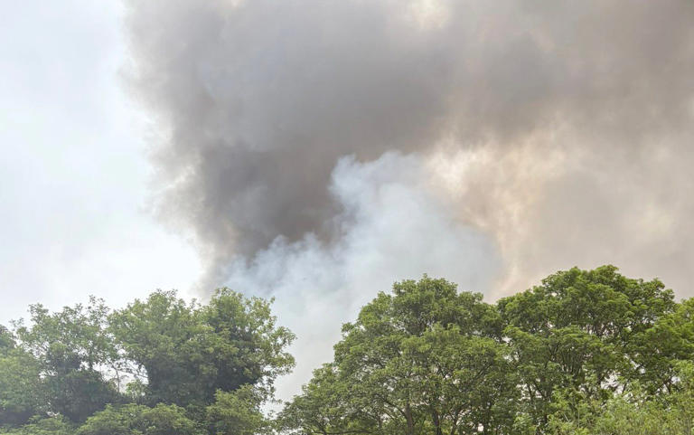 Smoke rises from the site of the former RAF Bicester, in Oxfordshire