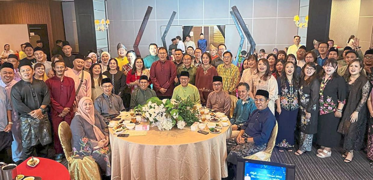 Julaihi (seated centre) with SWB staff at event where service awards are given out to staff.