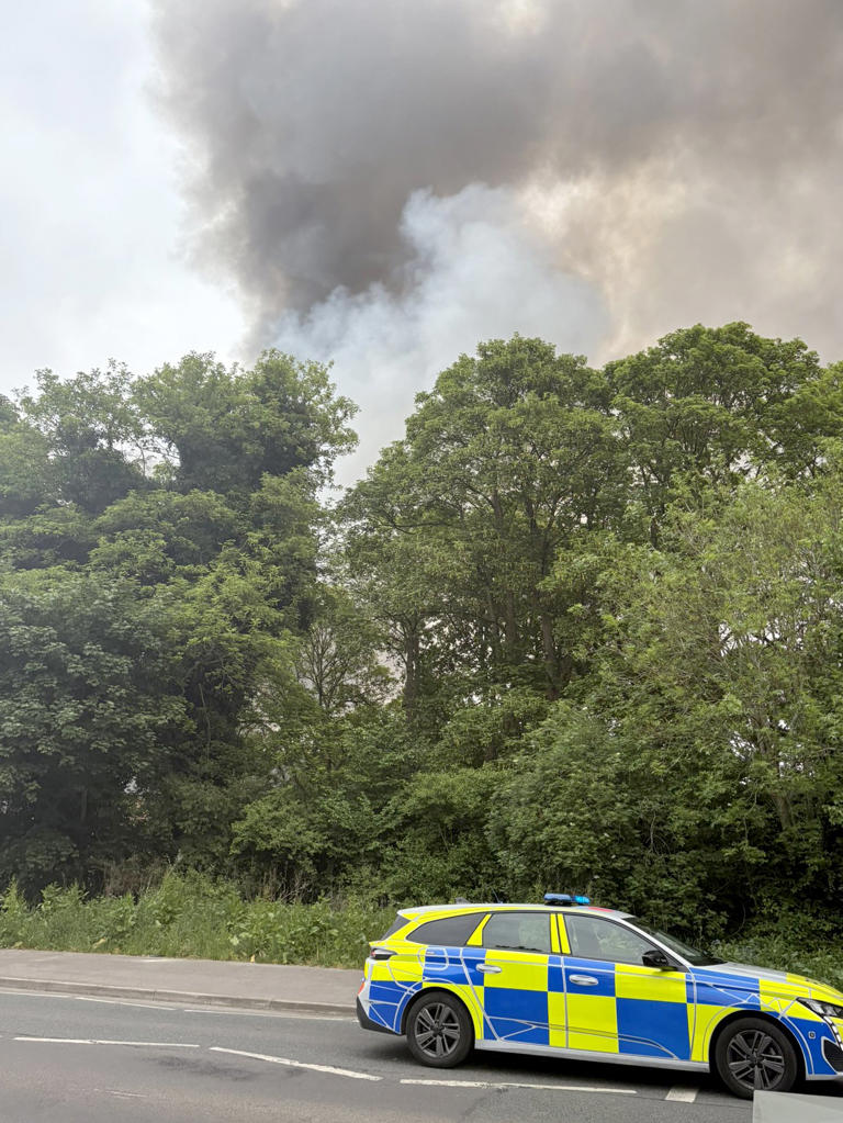 A police car near the scene of the blaze (@kajer87/Kieran McG/PA) (PA Media)